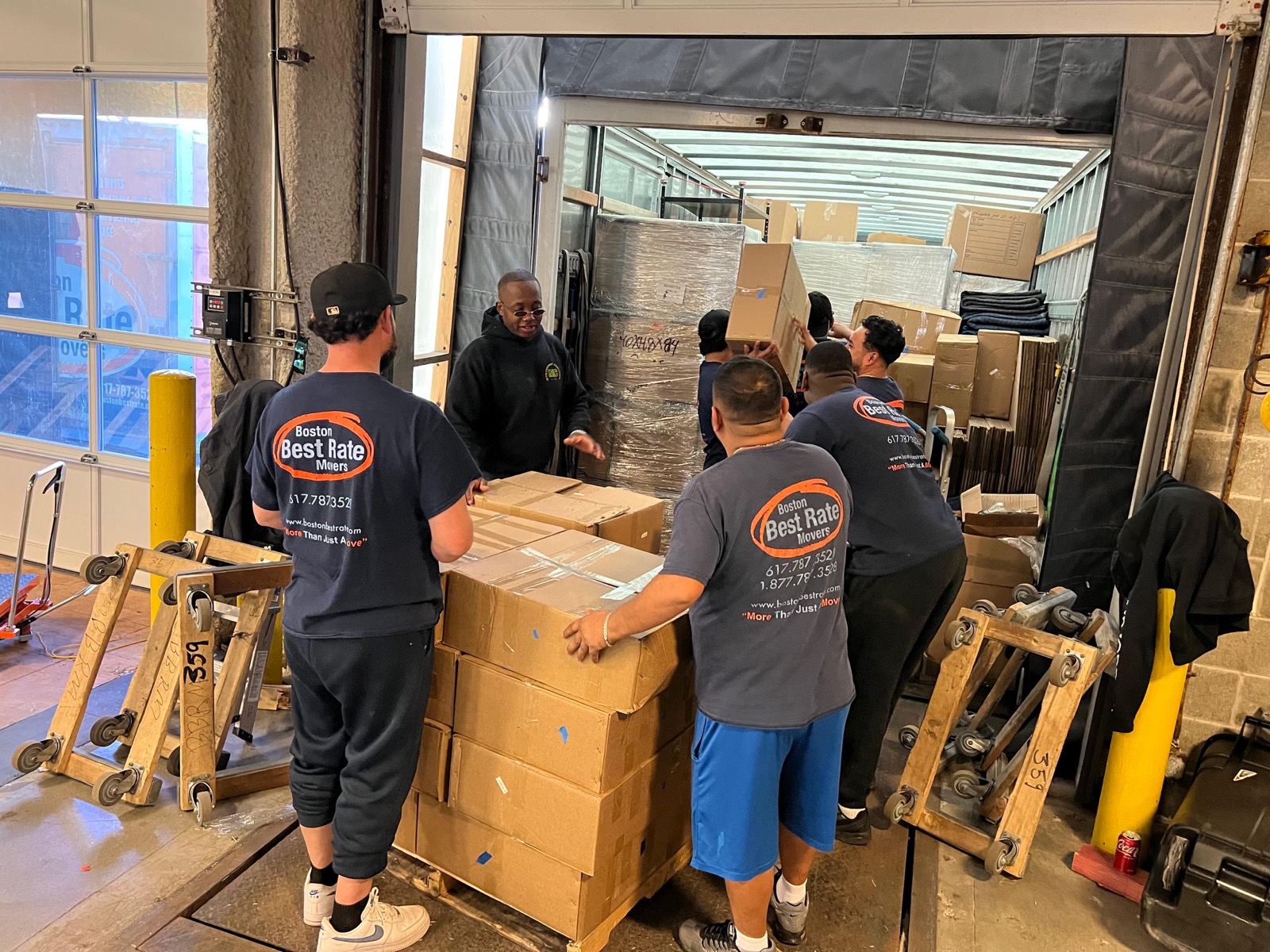 BBRM team of five loading boxes into truck at commercial dock