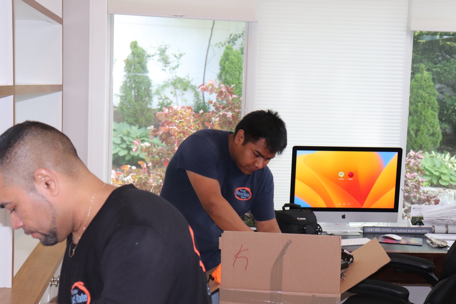 Two BBRM crew members assembling office furniture