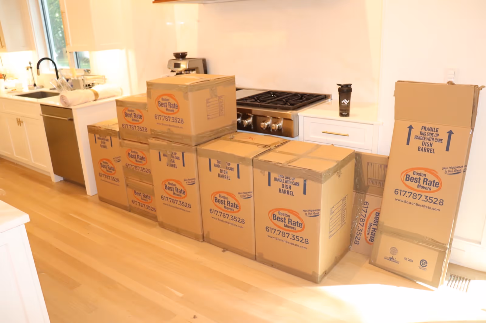 Branded moving boxes packed and ready on moving day in a modern kitchen