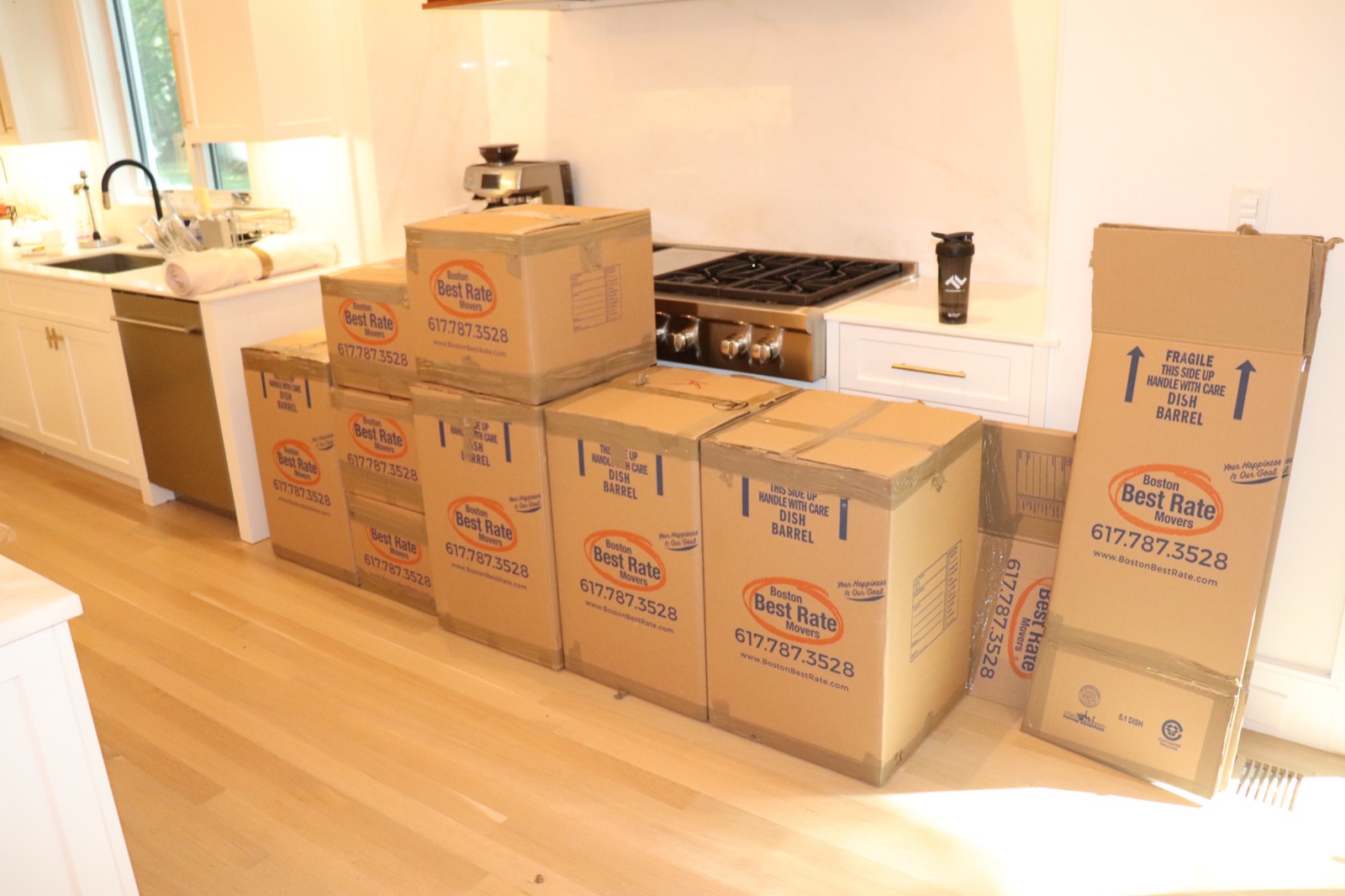 Branded moving boxes packed and ready on moving day in a modern kitchen