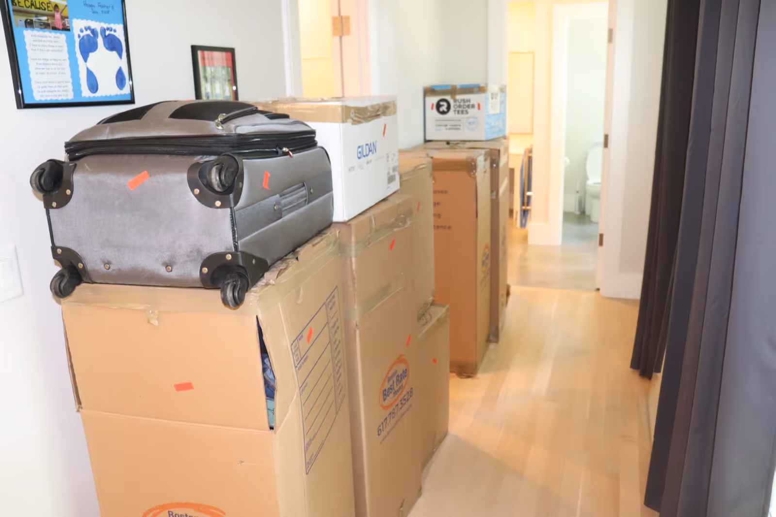 Packed boxes lined up in hallway during a residential move