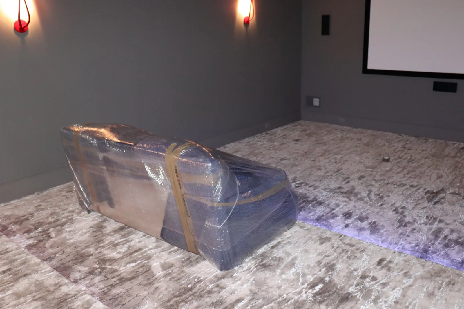 Furniture wrapped and protected in a home theater during a residential move