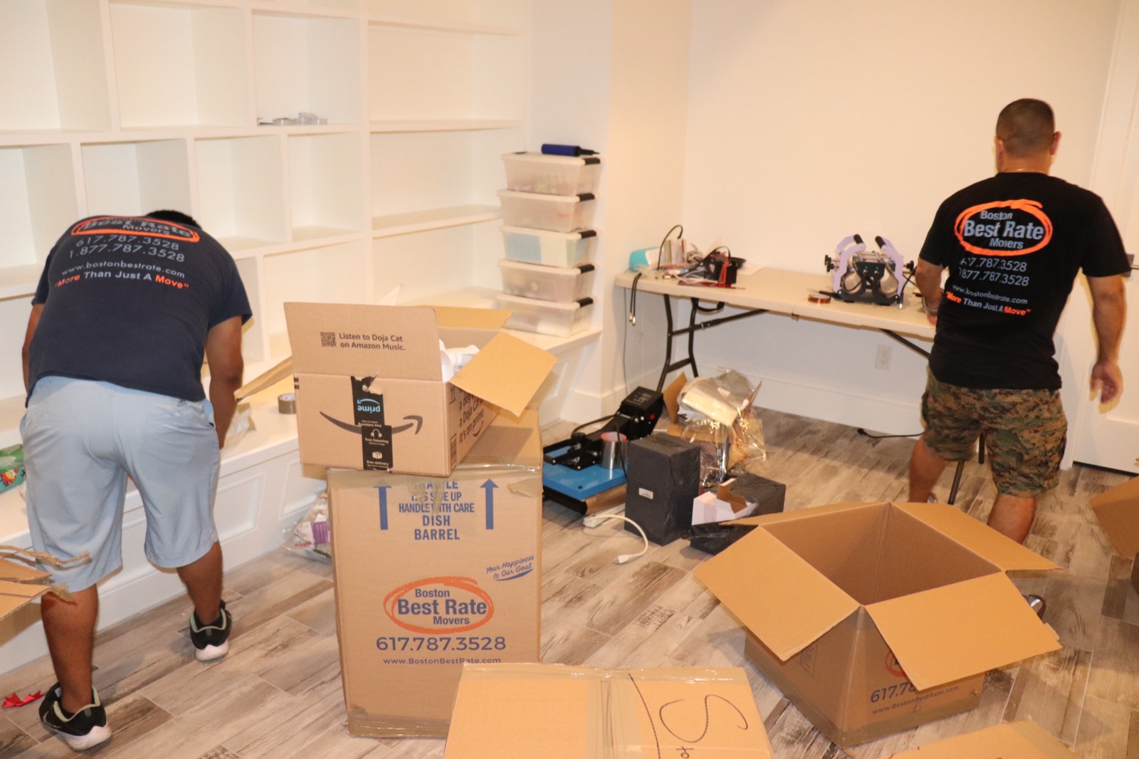 Two Boston Best Rate Movers crew members packing and organizing on the job