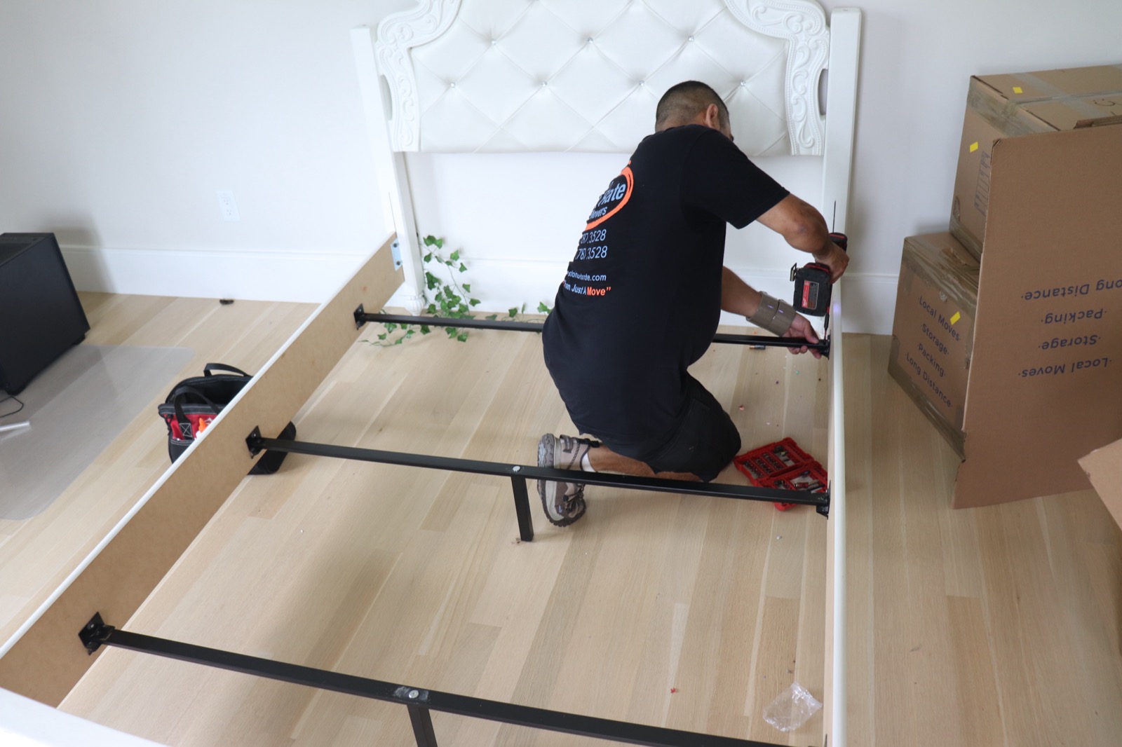 Boston Best Rate Movers crew member assembling furniture at destination