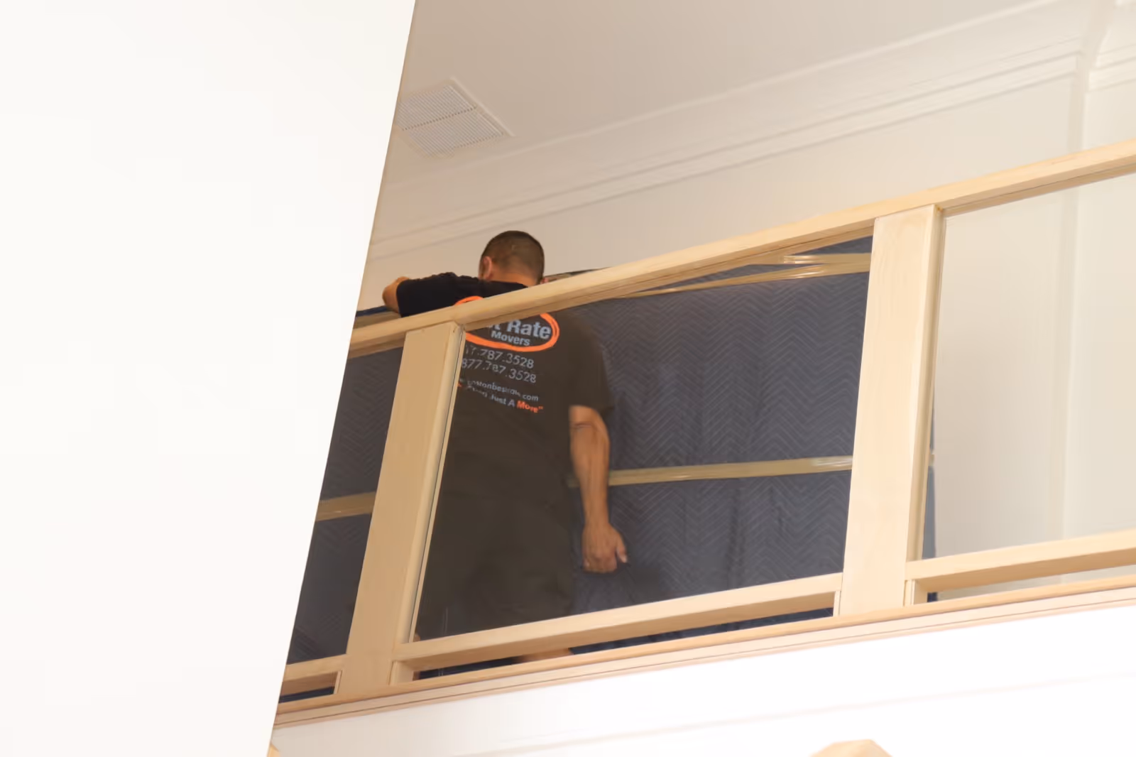Boston Best Rate Movers crew member moving a mattress on the upper level