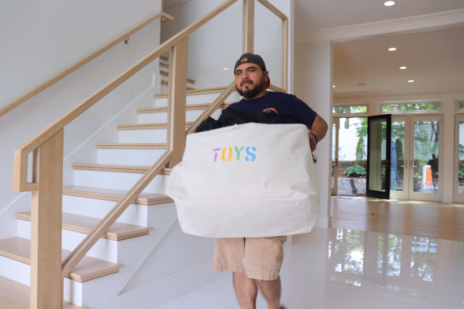 Boston Best Rate Movers crew member carefully moving items in a luxury home