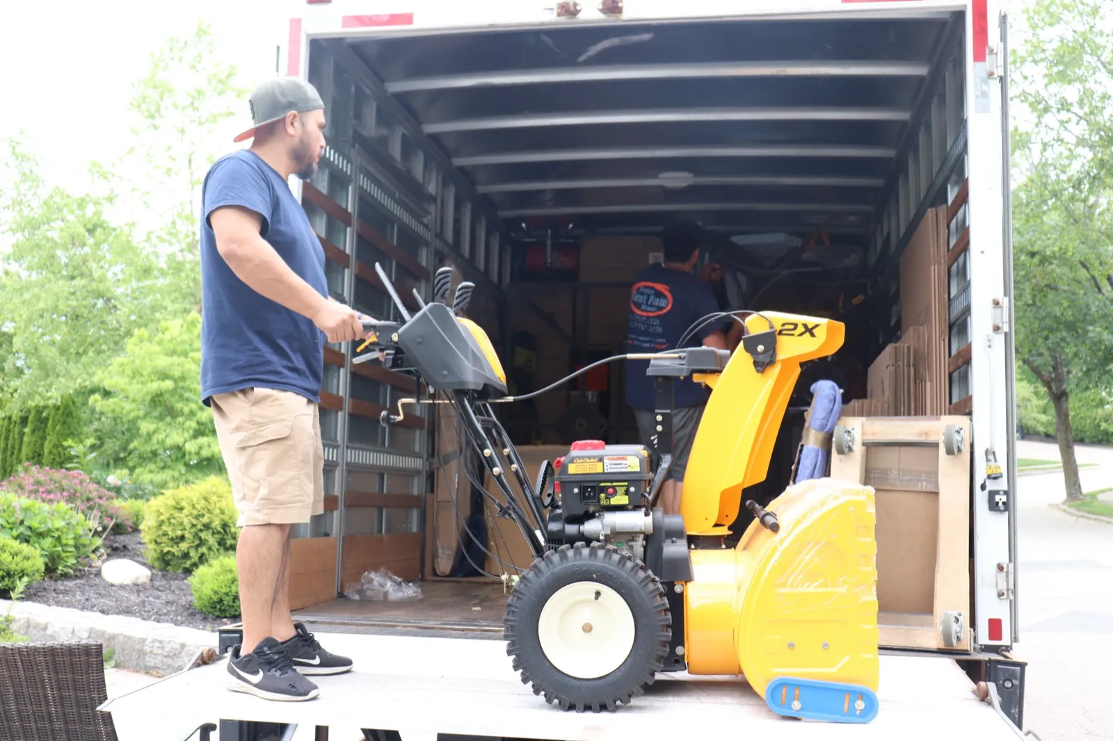 Boston Best Rate Movers crew loading heavy equipment onto truck