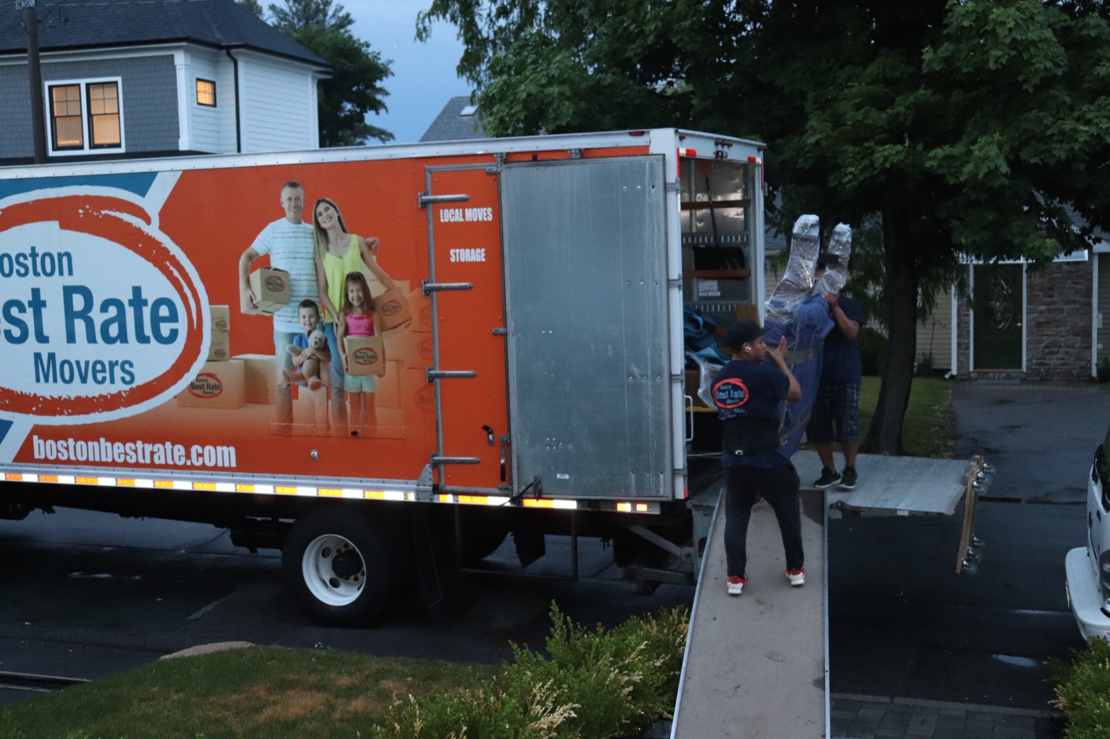 Boston Best Rate Movers crew loading wrapped furniture into truck