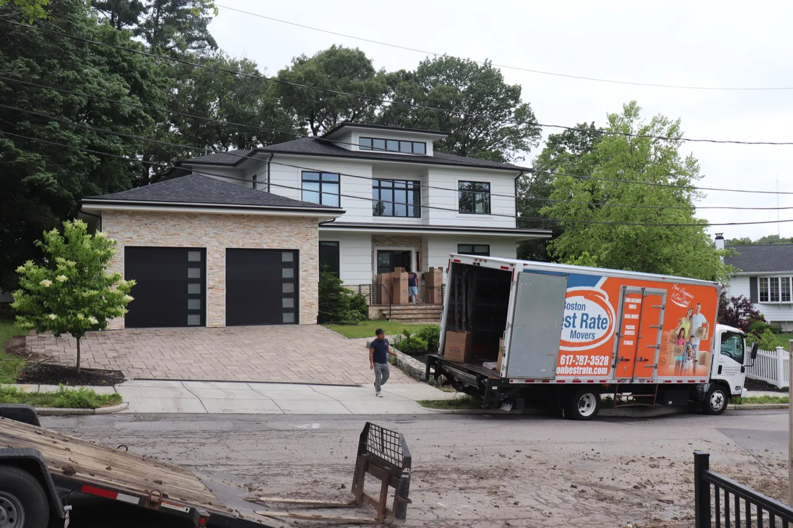 Boston Best Rate Movers truck at a luxury home during a move