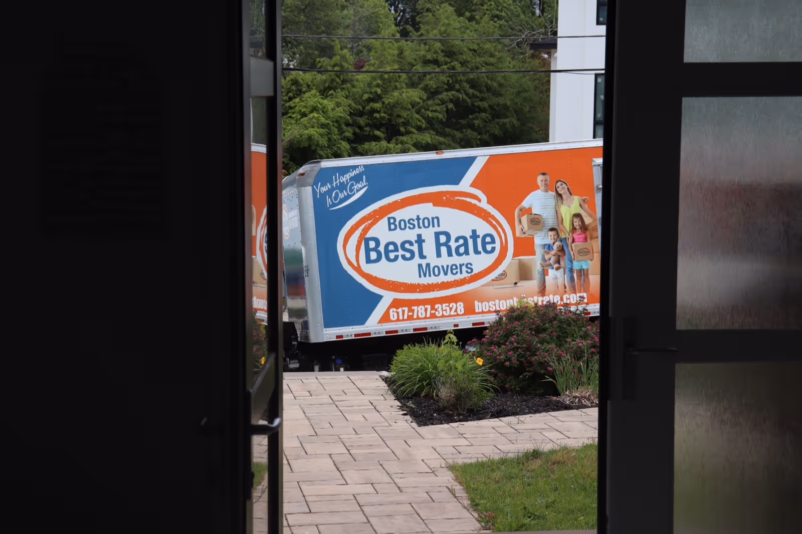 Boston Best Rate Movers truck visible from client's front door