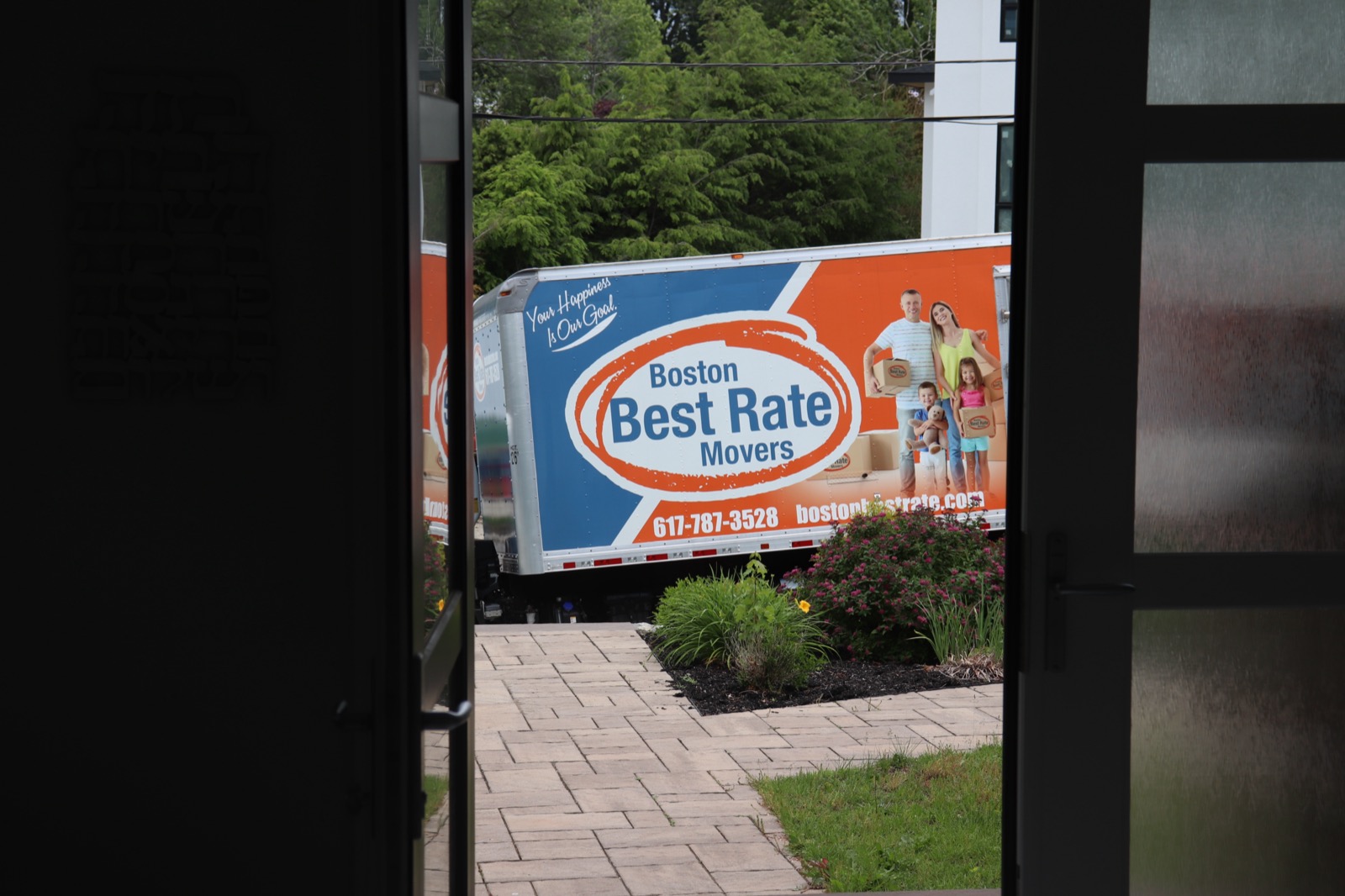 Boston Best Rate Movers truck visible from client's front door