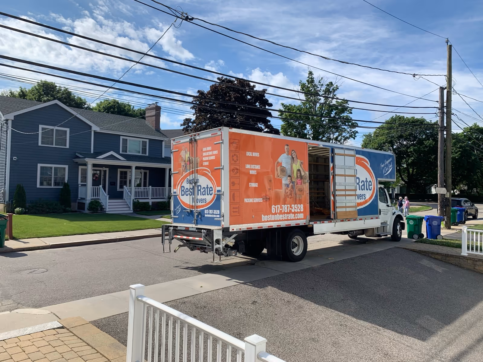 Boston Best Rate Movers truck with ramp deployed in suburban neighborhood